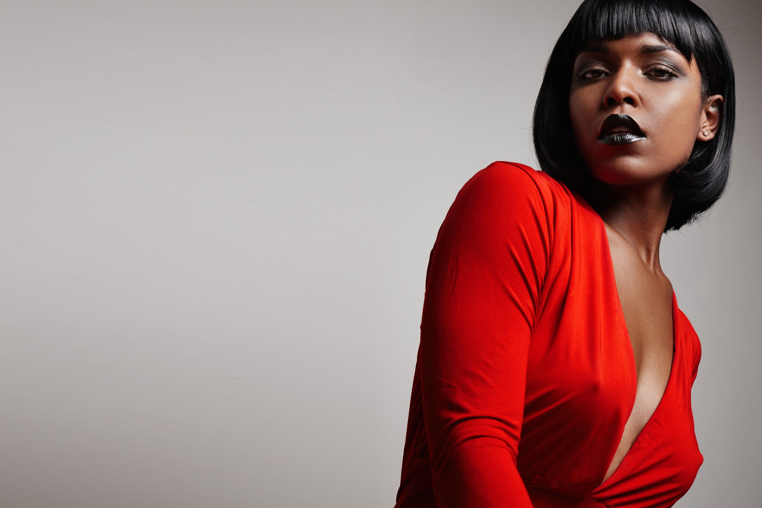 black woman with a straight short hair wearing red dress